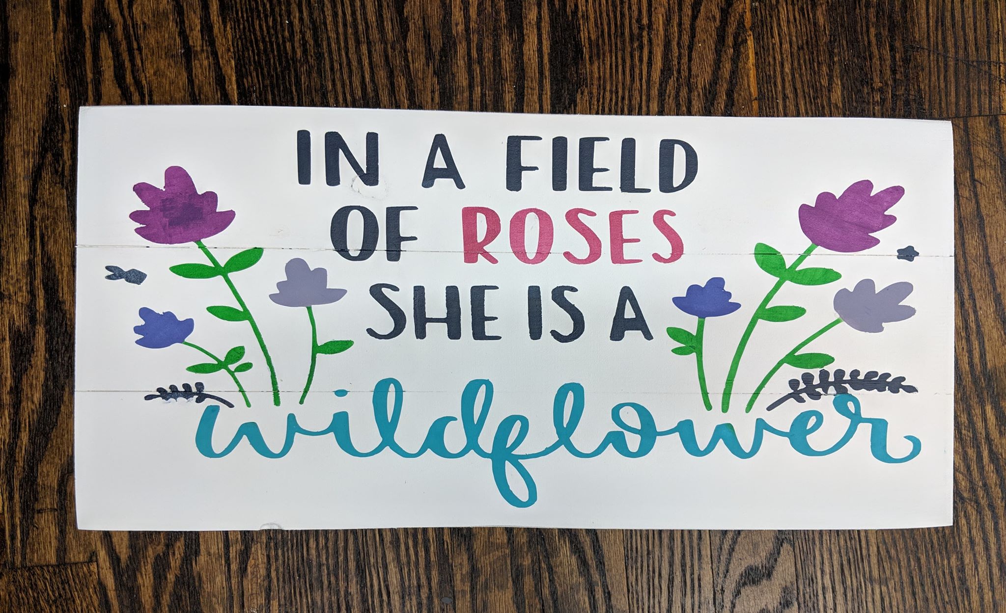 in a field of roses, she is a wild flower