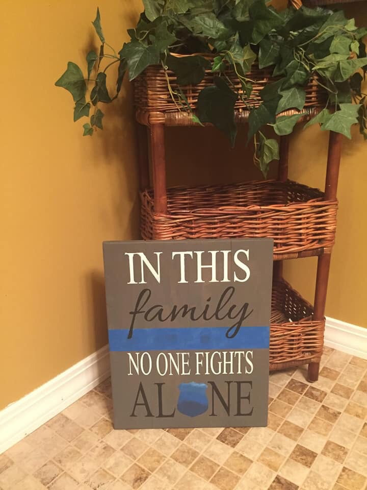In this family no one fights alone-police badge in alone
